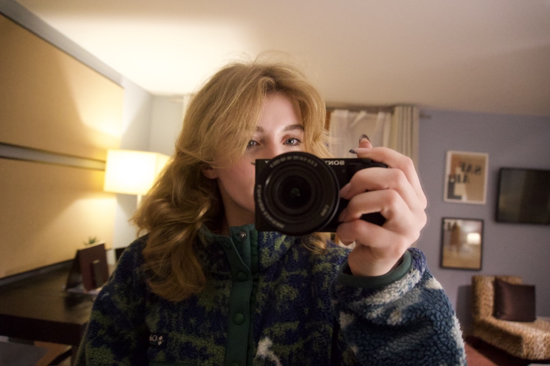 Camila, commercial photographer based in Barcelona, holding her camera